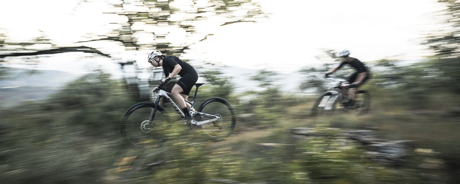 Cyclists riding cross country bikes on a trail